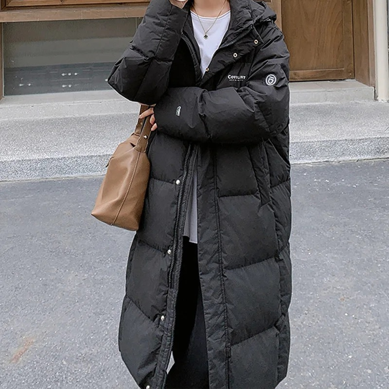 Dames lange gewatteerde pufferjas met capuchon, ritssluiting aan de voorkant en zijzakken