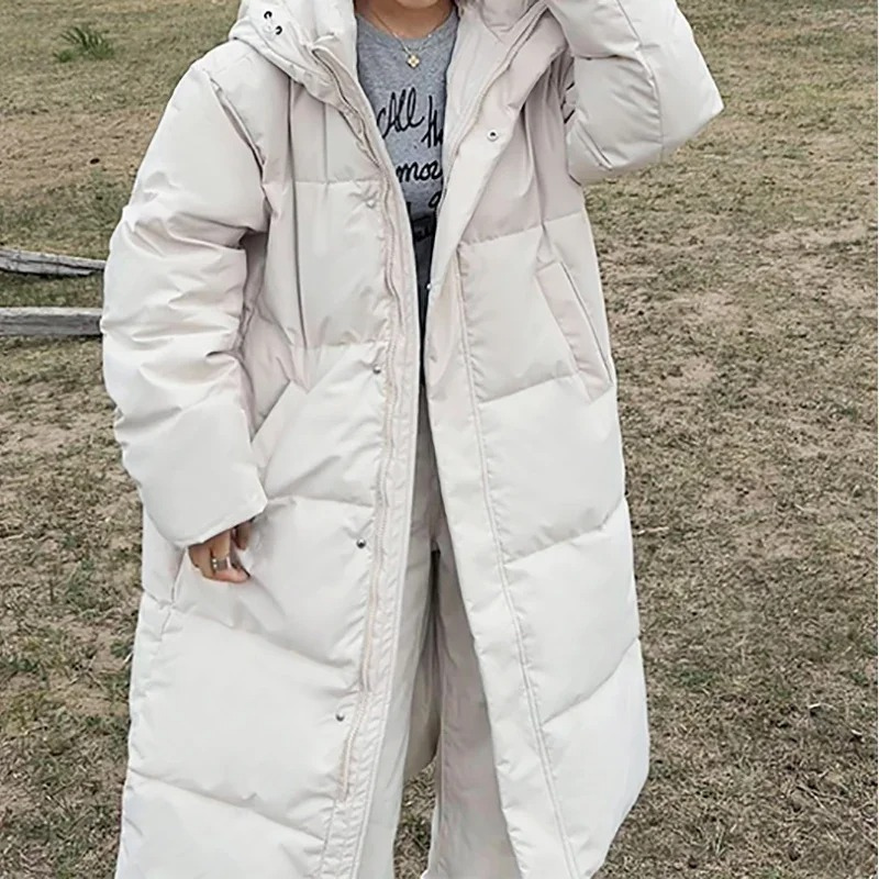 Dames lange gewatteerde pufferjas met capuchon, ritssluiting aan de voorkant en zijzakken