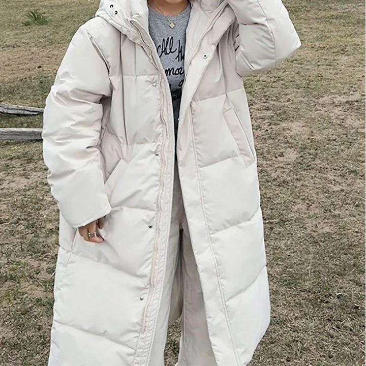 Dames lange gewatteerde pufferjas met capuchon, ritssluiting aan de voorkant en zijzakken