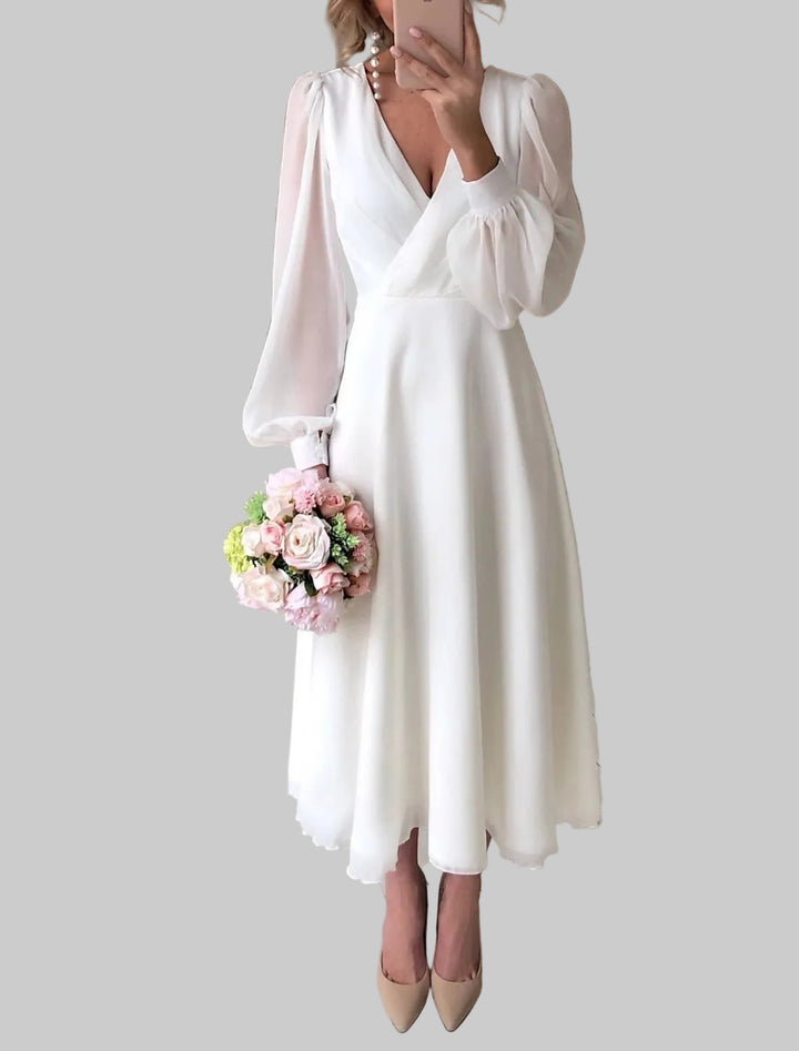 Dames midijurk met diepe V-hals, lange ballonmouwen en uitlopende rok